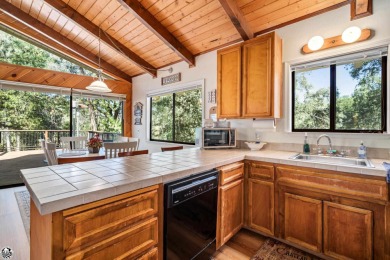 Relax and stay in this charming 3-bedroom, 2-bath cabin nestled on Pine Mountain Lake Country Club in California - for sale on GolfHomes.com, golf home, golf lot