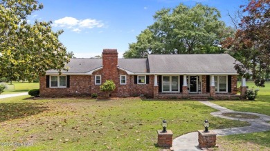 Discover this inviting brick ranch nestled on a serene .48-acre on River Bend Golf and Country Club in North Carolina - for sale on GolfHomes.com, golf home, golf lot