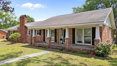 Discover this inviting brick ranch nestled on a serene .48-acre on River Bend Golf and Country Club in North Carolina - for sale on GolfHomes.com, golf home, golf lot