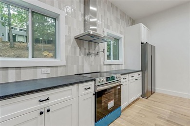 This stunning new construction blends luxury, functionality, and on The Highlands Course at Lake Arrowhead in Georgia - for sale on GolfHomes.com, golf home, golf lot