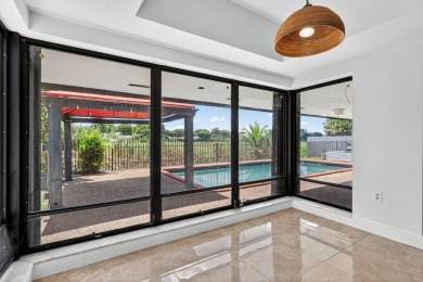 Stunning 4BR/2BA waterfront pool home in prestigious Country on Country Club of Miami in Florida - for sale on GolfHomes.com, golf home, golf lot