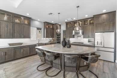 Discover unparalleled luxury in this David Weekley home, located on Verrado Golf Club - Victory in Arizona - for sale on GolfHomes.com, golf home, golf lot