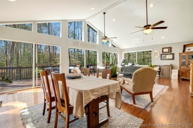This lovely home is snuggled amongst the trees in the gated & on Carolina Trace Country Club in North Carolina - for sale on GolfHomes.com, golf home, golf lot