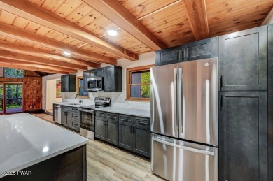 Situated on the golf course in Tanglwood Lakes, this stunning on Paupack Hills Golf and Country Club in Pennsylvania - for sale on GolfHomes.com, golf home, golf lot