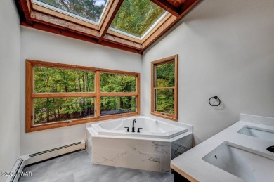 Situated on the golf course in Tanglwood Lakes, this stunning on Paupack Hills Golf and Country Club in Pennsylvania - for sale on GolfHomes.com, golf home, golf lot