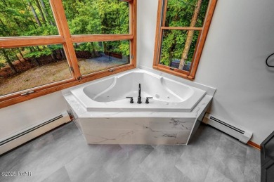 Situated on the golf course in Tanglwood Lakes, this stunning on Paupack Hills Golf and Country Club in Pennsylvania - for sale on GolfHomes.com, golf home, golf lot