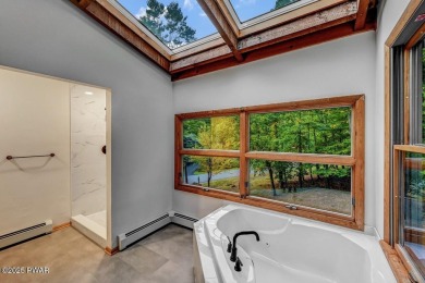 Situated on the golf course in Tanglwood Lakes, this stunning on Paupack Hills Golf and Country Club in Pennsylvania - for sale on GolfHomes.com, golf home, golf lot