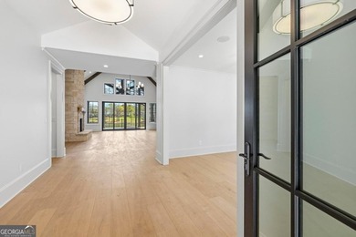 COMPLETELY RENOVATED. REIMAGINED. PRACTICALLY REBUILT FROM THE on Great Waters Course At Reynolds Plantation in Georgia - for sale on GolfHomes.com, golf home, golf lot