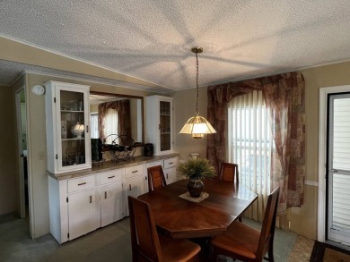 This charming 2-bedroom, 2-bathroom home offers stunning views on Lake Henry Golf Club in Florida - for sale on GolfHomes.com, golf home, golf lot