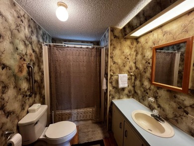 This charming 2-bedroom, 2-bathroom home offers stunning views on Lake Henry Golf Club in Florida - for sale on GolfHomes.com, golf home, golf lot