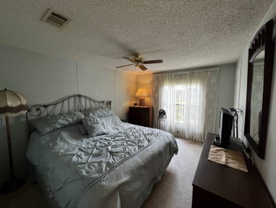 This charming 2-bedroom, 2-bathroom home offers stunning views on Lake Henry Golf Club in Florida - for sale on GolfHomes.com, golf home, golf lot