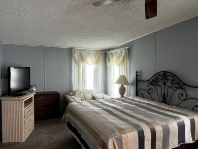 This charming 2-bedroom, 2-bathroom home offers stunning views on Lake Henry Golf Club in Florida - for sale on GolfHomes.com, golf home, golf lot