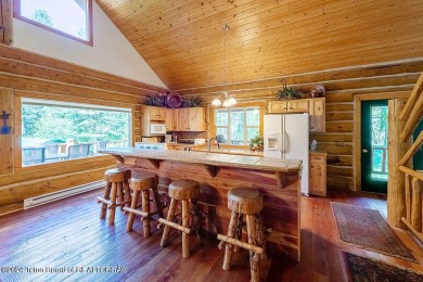 Escape to your own hand-hewn log retreat nestled in the woods of on Cedar Creek Golf Course in Wyoming - for sale on GolfHomes.com, golf home, golf lot