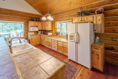 Escape to your own hand-hewn log retreat nestled in the woods of on Cedar Creek Golf Course in Wyoming - for sale on GolfHomes.com, golf home, golf lot