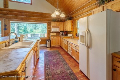 Escape to your own hand-hewn log retreat nestled in the woods of on Cedar Creek Golf Course in Wyoming - for sale on GolfHomes.com, golf home, golf lot