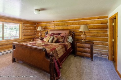 Escape to your own hand-hewn log retreat nestled in the woods of on Cedar Creek Golf Course in Wyoming - for sale on GolfHomes.com, golf home, golf lot