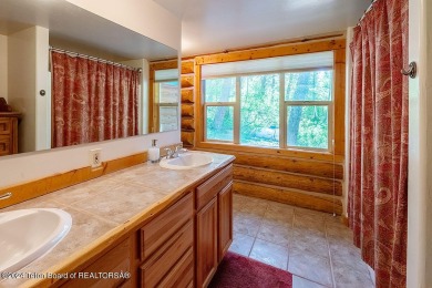 Escape to your own hand-hewn log retreat nestled in the woods of on Cedar Creek Golf Course in Wyoming - for sale on GolfHomes.com, golf home, golf lot