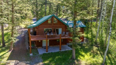 Escape to your own hand-hewn log retreat nestled in the woods of on Cedar Creek Golf Course in Wyoming - for sale on GolfHomes.com, golf home, golf lot