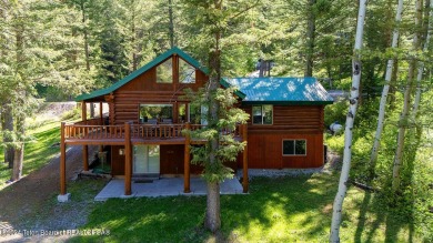 Escape to your own hand-hewn log retreat nestled in the woods of on Cedar Creek Golf Course in Wyoming - for sale on GolfHomes.com, golf home, golf lot