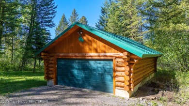 Escape to your own hand-hewn log retreat nestled in the woods of on Cedar Creek Golf Course in Wyoming - for sale on GolfHomes.com, golf home, golf lot