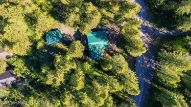 Escape to your own hand-hewn log retreat nestled in the woods of on Cedar Creek Golf Course in Wyoming - for sale on GolfHomes.com, golf home, golf lot