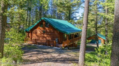 Escape to your own hand-hewn log retreat nestled in the woods of on Cedar Creek Golf Course in Wyoming - for sale on GolfHomes.com, golf home, golf lot