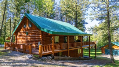 Escape to your own hand-hewn log retreat nestled in the woods of on Cedar Creek Golf Course in Wyoming - for sale on GolfHomes.com, golf home, golf lot