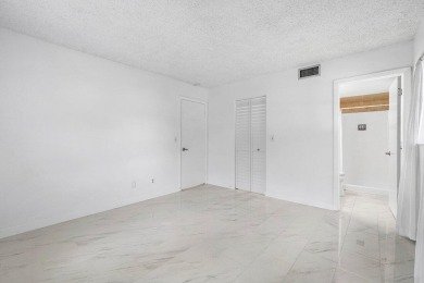 Embrace easy living in this sunlit 2BR/2BA end-unit condo in on The Little Club in Florida - for sale on GolfHomes.com, golf home, golf lot