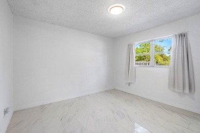 Embrace easy living in this sunlit 2BR/2BA end-unit condo in on The Little Club in Florida - for sale on GolfHomes.com, golf home, golf lot