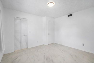 Embrace easy living in this sunlit 2BR/2BA end-unit condo in on The Little Club in Florida - for sale on GolfHomes.com, golf home, golf lot