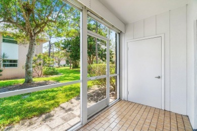 Embrace easy living in this sunlit 2BR/2BA end-unit condo in on The Little Club in Florida - for sale on GolfHomes.com, golf home, golf lot