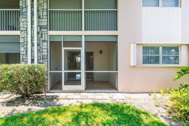 Embrace easy living in this sunlit 2BR/2BA end-unit condo in on The Little Club in Florida - for sale on GolfHomes.com, golf home, golf lot