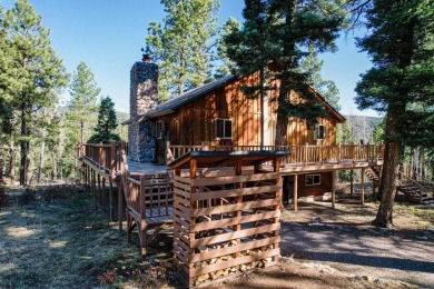 Discover this 2,293 square foot woodland getaway featuring four on El Valle Escondido Golf Course in New Mexico - for sale on GolfHomes.com, golf home, golf lot
