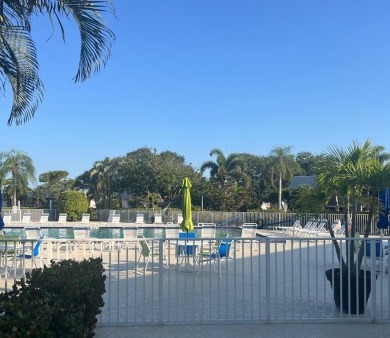 Embrace easy living in this sunlit 2BR/2BA end-unit condo in on The Little Club in Florida - for sale on GolfHomes.com, golf home, golf lot