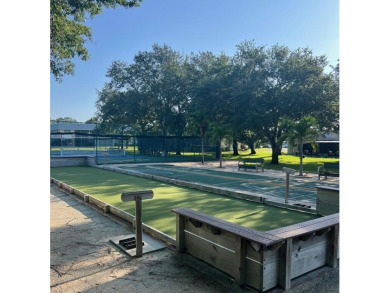 Embrace easy living in this sunlit 2BR/2BA end-unit condo in on The Little Club in Florida - for sale on GolfHomes.com, golf home, golf lot