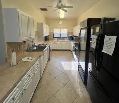 Embrace easy living in this sunlit 2BR/2BA end-unit condo in on The Little Club in Florida - for sale on GolfHomes.com, golf home, golf lot