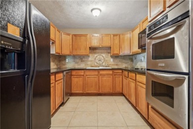 This charming Mid-Century home in Lithonia's Saddlewood on Mystery Valley Golf Course in Georgia - for sale on GolfHomes.com, golf home, golf lot
