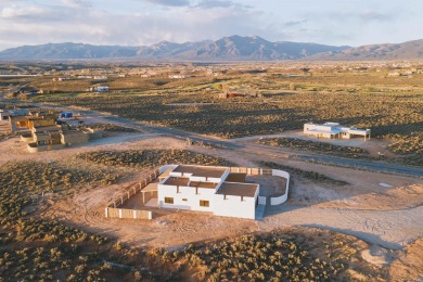 Discover the perfect blend of modern luxury and Southwest charm on Taos Country Club in New Mexico - for sale on GolfHomes.com, golf home, golf lot