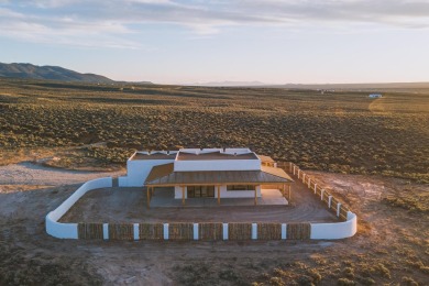 Discover the perfect blend of modern luxury and Southwest charm on Taos Country Club in New Mexico - for sale on GolfHomes.com, golf home, golf lot