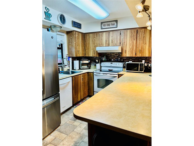 Charming 3 Bedroom 2 Bathroom Home in the *W* Section of Palm on The Grand Club - Pine Lakes Course in Florida - for sale on GolfHomes.com, golf home, golf lot