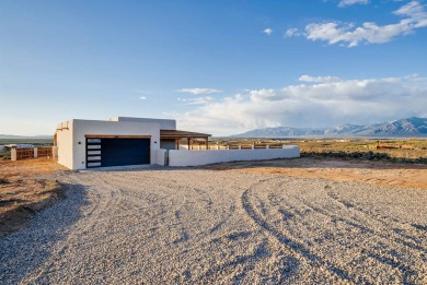 Discover the perfect blend of modern luxury and Southwest charm on Taos Country Club in New Mexico - for sale on GolfHomes.com, golf home, golf lot