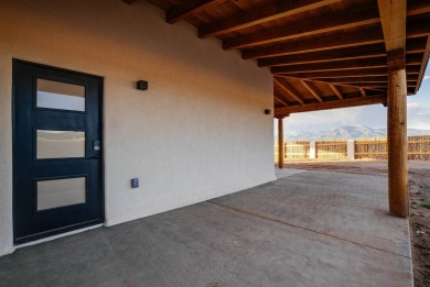 Discover the perfect blend of modern luxury and Southwest charm on Taos Country Club in New Mexico - for sale on GolfHomes.com, golf home, golf lot