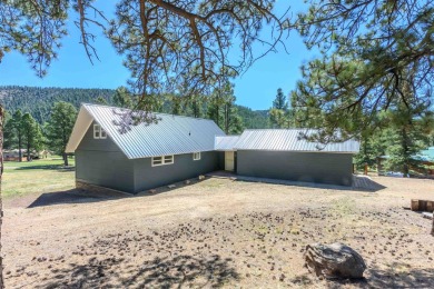Settle into this charming mountain home overlooking the 11th on Angel Fire Resort Country Club in New Mexico - for sale on GolfHomes.com, golf home, golf lot