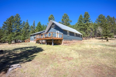 Settle into this charming mountain home overlooking the 11th on Angel Fire Resort Country Club in New Mexico - for sale on GolfHomes.com, golf home, golf lot