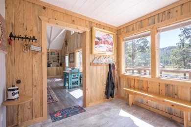 Settle into this charming mountain home overlooking the 11th on Angel Fire Resort Country Club in New Mexico - for sale on GolfHomes.com, golf home, golf lot