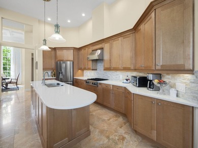 THIS GRACIOUS CUSTOM HOME HAS A GOLF MEMBERSHIP, GOLF AND LAKE on BallenIsles Golf and Country Club in Florida - for sale on GolfHomes.com, golf home, golf lot