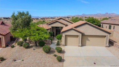 Imagine stepping into a charming 3-bedroom, 2-bathroom home on Laughlin Ranch Golf Club in Arizona - for sale on GolfHomes.com, golf home, golf lot