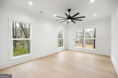 Relax and gaze upon the peaceful water view of this interior on Harbor Club Golf and Country Club in Georgia - for sale on GolfHomes.com, golf home, golf lot