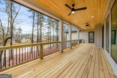 Relax and gaze upon the peaceful water view of this interior on Harbor Club Golf and Country Club in Georgia - for sale on GolfHomes.com, golf home, golf lot