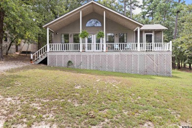 Welcome to your turn-key retreat in the heart of East Texas! on Holly Lake Ranch Golf Club in Texas - for sale on GolfHomes.com, golf home, golf lot